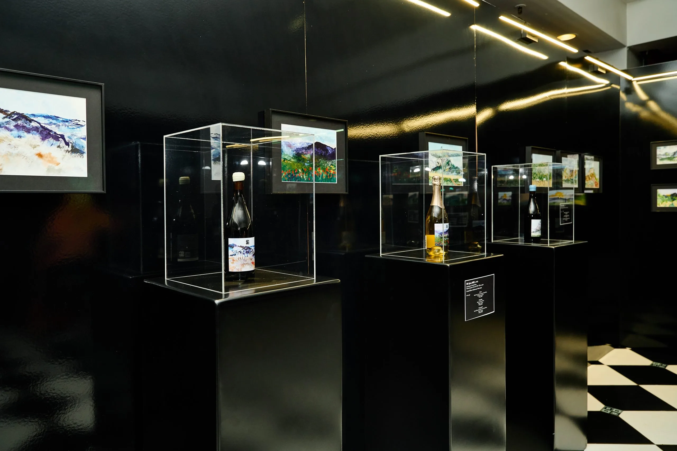 Limited-edition artist-label South African white and red wine bottles on display at iGOLI and House of Sisters Grimm immersive art gallery in London.
